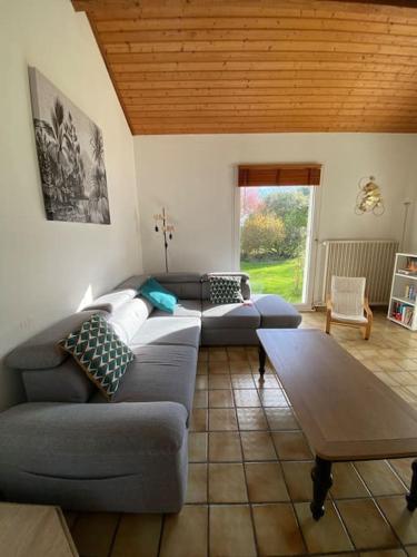 un salon avec un canapé et une table dans l'établissement Maison familiale 4 chambres avec grand jardin, particulier, à Corsept