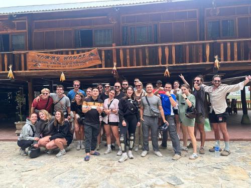 a group of people posing for a picture in front of a building at Homestay Tommy House in Ha Giang