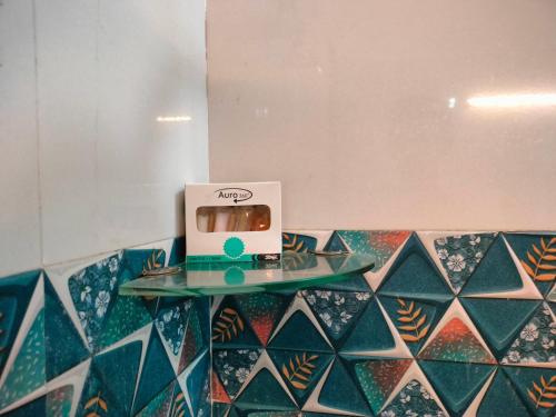 a laptop sitting on a glass table on a tiled counter at Blue Heart Home 1 BHK - Spacious Flat in Tapovan in Rishīkesh