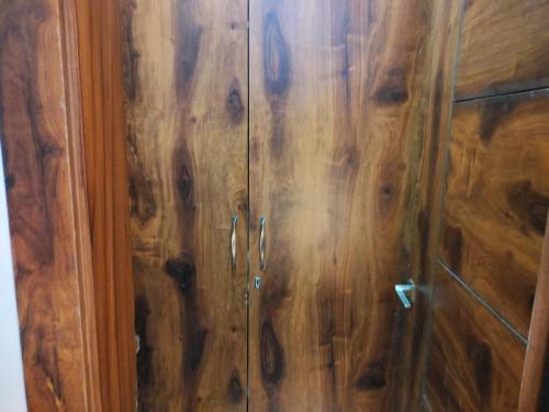 a wooden cabinet with wood paneling at Blue Heart Home 1 BHK - Spacious Flat in Tapovan in Rishīkesh