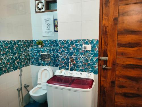 a small bathroom with a toilet and a sink at Blue Heart Home 1 BHK - Spacious Flat in Tapovan in Rishīkesh