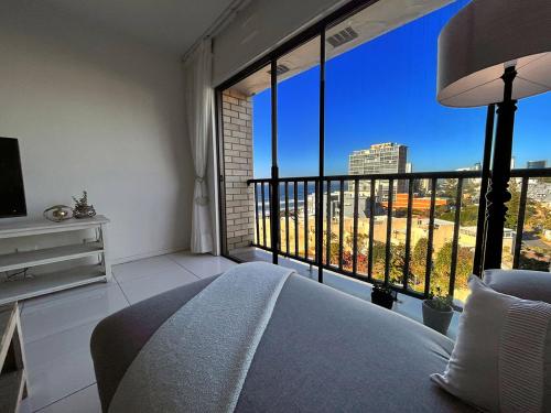 a bedroom with a bed and a large window at 503 Hawaan View in Durban