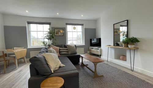 a living room with a couch and a table at Apartment 4 St Georges in Cheltenham