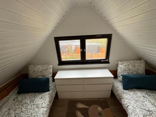 a room with two beds and a window at Hidden Cottage Odenwald in Wald-Michelbach