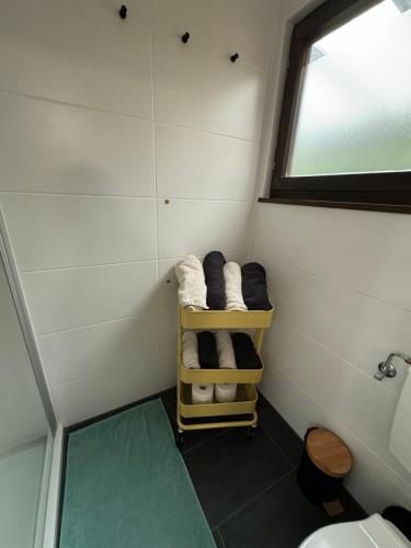 a small bathroom with a towel rack and a window at Hidden Cottage Odenwald in Wald-Michelbach