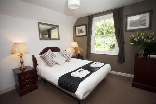 a bedroom with a large bed and a large window at The Five Bells in Deal