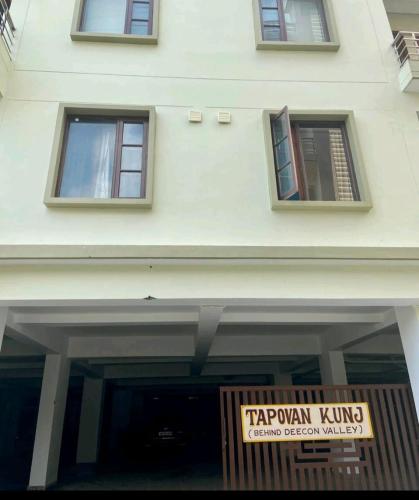 a building with a sign on the front of it at Blue Heart Home 1 BHK - Spacious Flat in Tapovan in Rishīkesh
