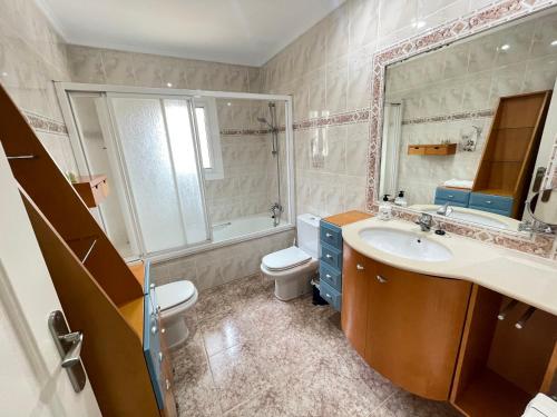 a bathroom with a sink and a toilet and a mirror at Casa Maica in Lliria