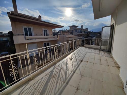 a balcony with a view of a building at Finikas Spata Holiday Apartment in Spáta