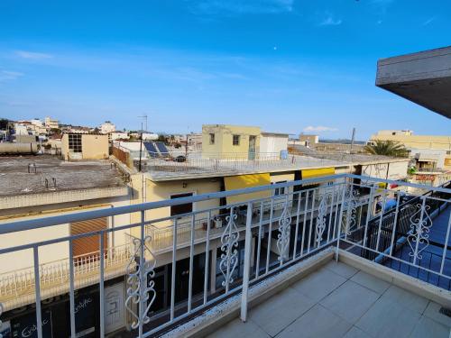 a balcony with a train on top of a building at Finikas Spata Holiday Apartment in Spáta