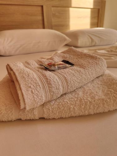 a towel sitting on top of a bed at Finikas Spata Holiday Apartment in Spáta