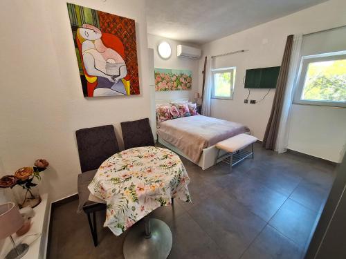 a bedroom with a bed and a table in it at By the Mill in Rogoznica