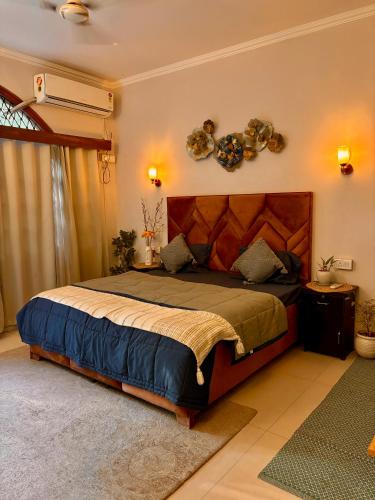 a bedroom with a large bed in a room at Atharva's Homestay by Goaround Homes in New Delhi