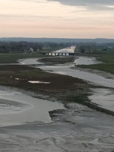 an aerial view of a river with a bridge in the background at La Lendeline in Saint-Sauveur-Lendelin