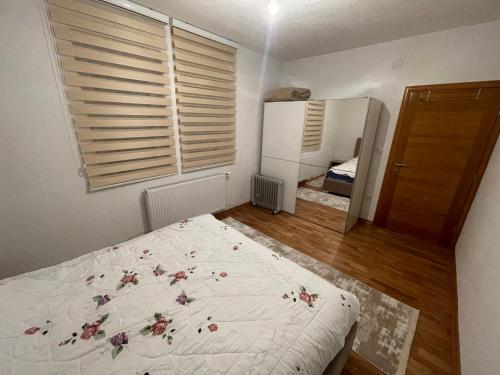 a bedroom with a bed with flowers on it at Lina Apartmani in Plav