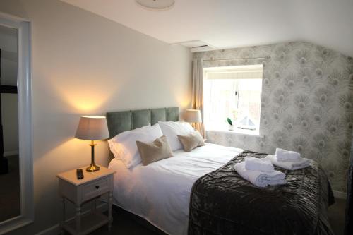 a bedroom with a bed with towels on it at Sterling House @ Short Stays in Basingstoke