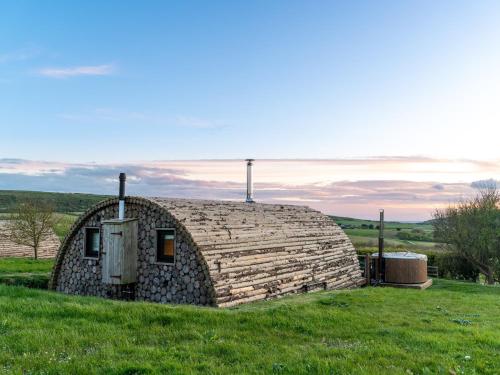 a large stone building in a field with green grass at Modulog 2 At Tapnell Farm in Yarmouth