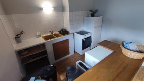 a small kitchen with a sink and a refrigerator at L'appart des princes in Combourg