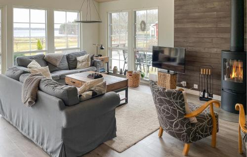 a living room with a couch and a fireplace at Lovely Home In Glanshammar With Kitchen in Glanshammar