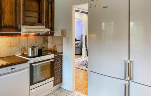 a kitchen with a stainless steel refrigerator at Amazing Home In Enhörna With Sauna in Enhörna