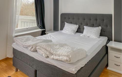 a bedroom with a large bed with white sheets at Amazing Home In Enhörna With Sauna in Enhörna