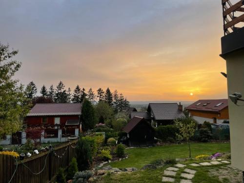 a view of a yard with houses at sunset at Chata Olomouc Tovéř in Tovéř
