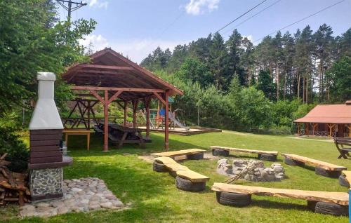a park with benches and a pavilion in the grass at Amazing Apartment In Tumiany With Wifi in Tumiany
