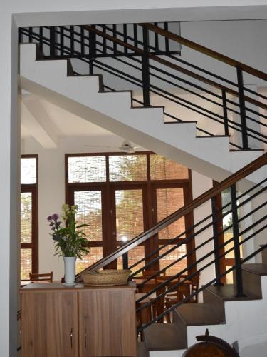 a spiral staircase in a home with a stair case at SaDev Lake Villa Bandaragama in Bandaragama