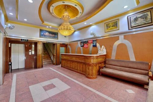 a lobby with a large organ in a building at Hotel President in Gorakhpur