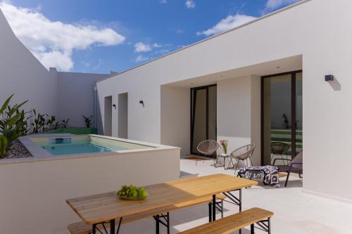 a patio with a table and a swimming pool at Canto 18 in Salir de Porto