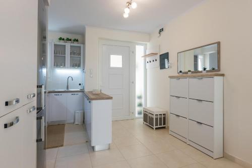 a kitchen with white cabinets and a sink at Mylarakia in Chios