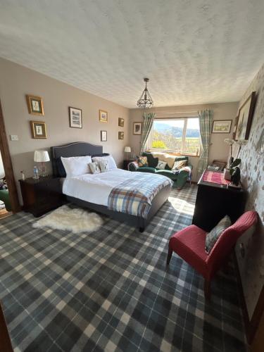 a bedroom with a bed and a couch and a chair at The Guest suite at Daviot ,Inverness in Inverness
