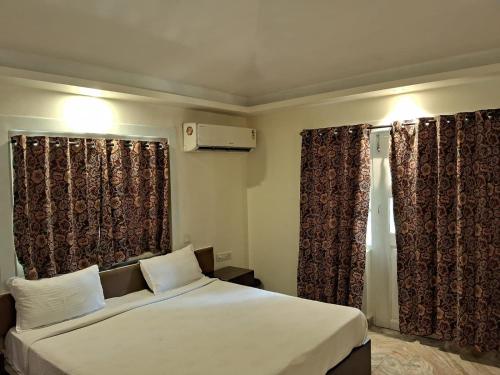 Ένα ή περισσότερα κρεβάτια σε δωμάτιο στο Bhagyoday