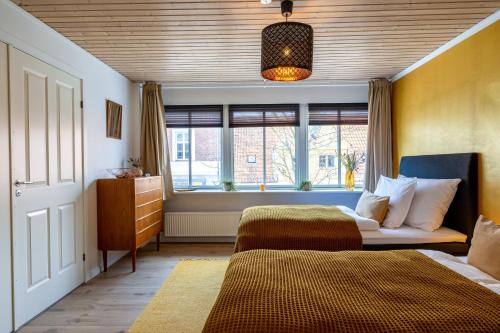 a bedroom with two beds and a window at Cozy Apartment Stevns in Store Heddinge