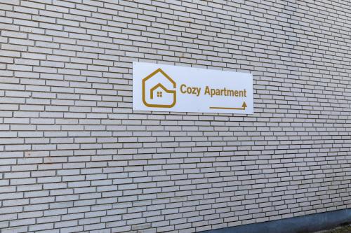 a sign on the side of a brick building at Cozy Apartment Stevns in Store Heddinge