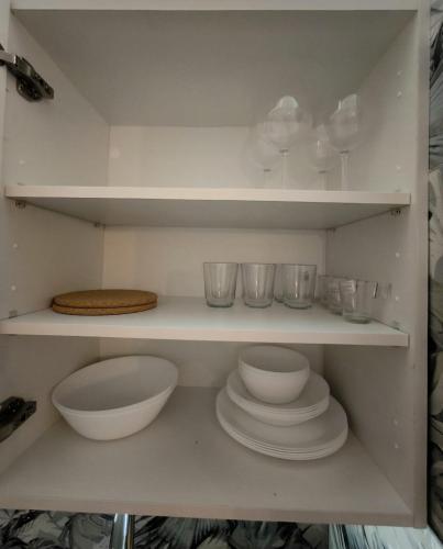 a shelf with plates and bowls and glasses on it at Golf vila3 in San Miguel de Abona