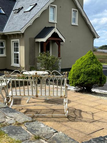 a wooden bench sitting in front of a house at The Lodge Donegal Town in Donegal