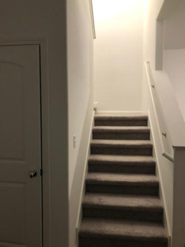 a staircase in a house with a stair case at Huge Master Suite Attached Bath, Fridge, TV 20 Mins To Tesla in Manor