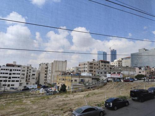 a group of cars parked in a city with buildings at Gentle Breeze Studio 2 in Amman
