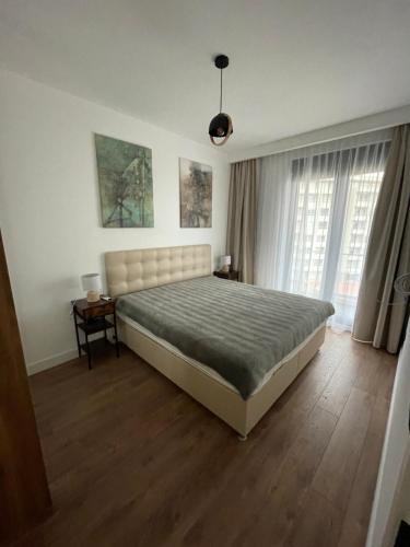 a bedroom with a large bed in a room at APARTMENT IVIL - ELIA RESIDENCE in Becici