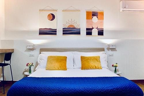 a bedroom with a bed with blue sheets and yellow pillows at MaryGrace B&B in Castellammare di Stabia