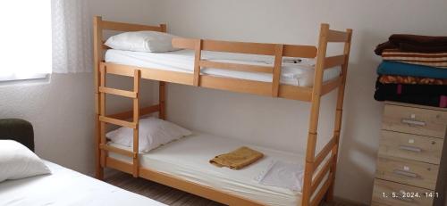 a bedroom with two bunk beds with white sheets at Hostel Dada in Mostar