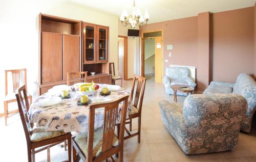 a dining room and living room with a table and chairs at Lovely Apartment In Tuoro Sul Trasimeno in Tuoro sul Trasimeno