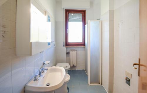 a white bathroom with a sink and a toilet at Lovely Apartment In Tuoro Sul Trasimeno in Tuoro sul Trasimeno