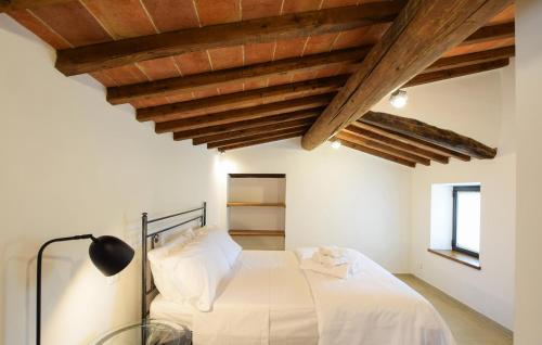a bedroom with a white bed with wooden ceilings at Beautiful Apartment In Castel Focognano in Castel Focognano