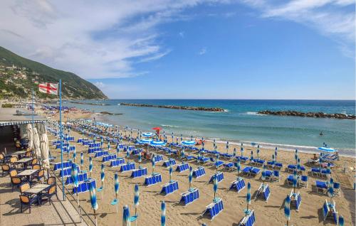 a beach with chairs and umbrellas and the ocean at Nice Apartment In Framura With Kitchen in Framura