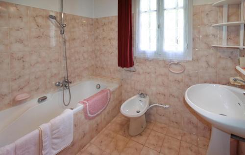 2 Bedroom Nice Home In Moustiers-sainte-marie في موستيه سانت ماري: حمام مع حوض وحوض استحمام ومرحاض