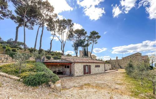 an exterior view of a stone house with trees at Nice Home In Petroro With Wifi in Petroro
