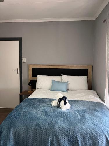 a stuffed animal sitting on top of a bed at Bella Hideaway Villa in East London