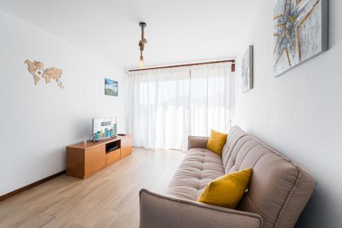 a living room with a couch and a table at GuestReady - Esposende Beach Place in Esposende